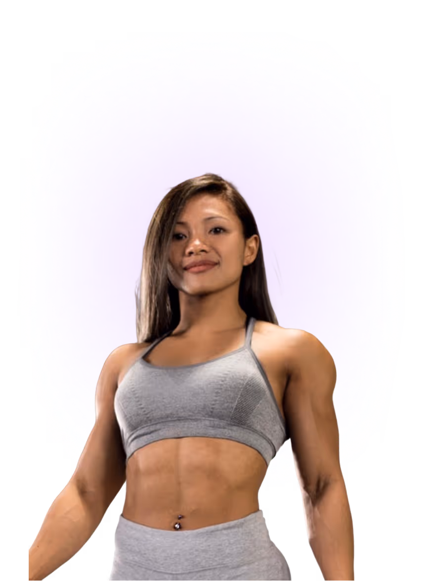 Fit young woman with long hair wearing grey sports bra and leggings, posing confidently.